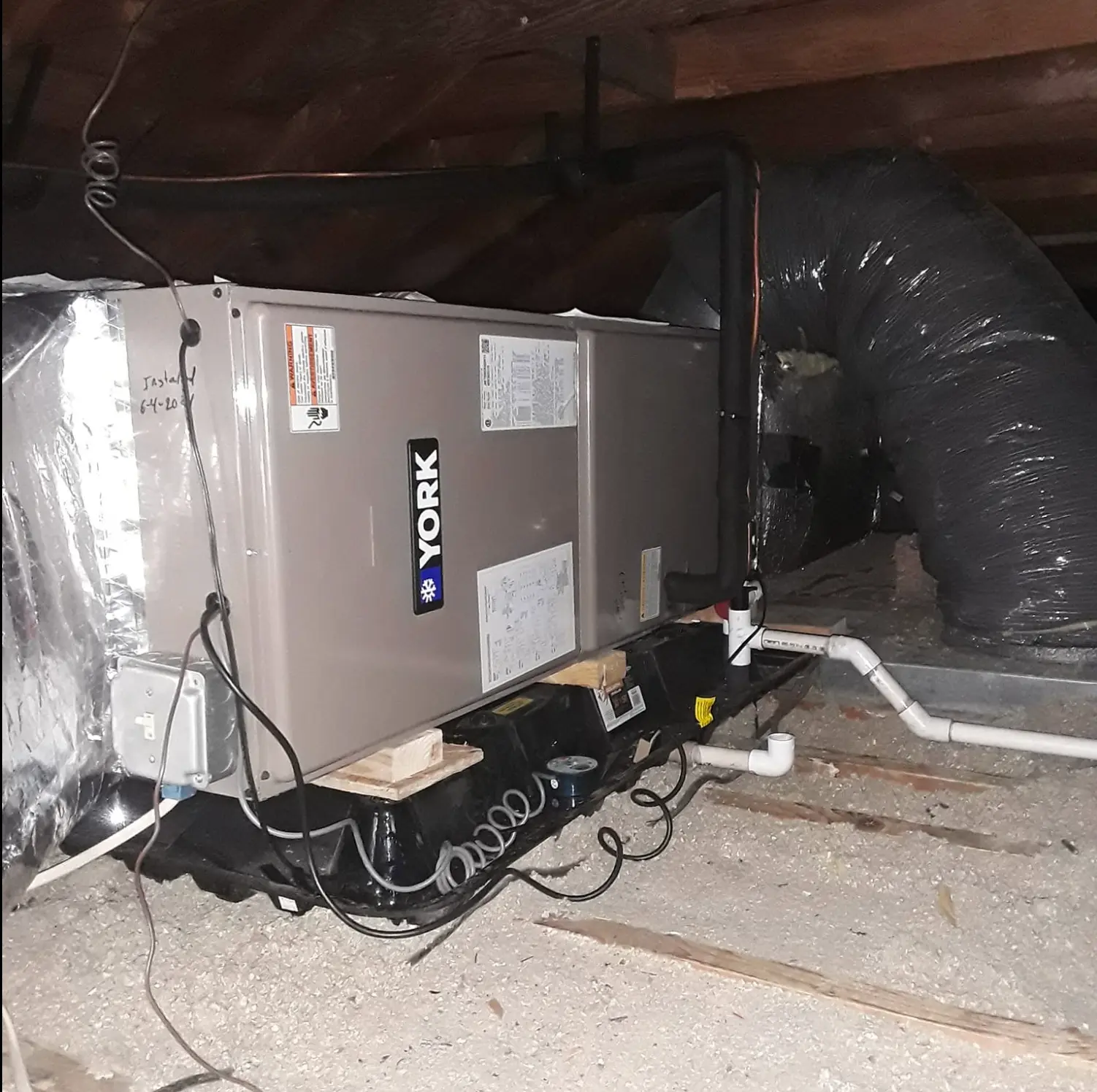 Air handler and insulated ductwork installed in an attic