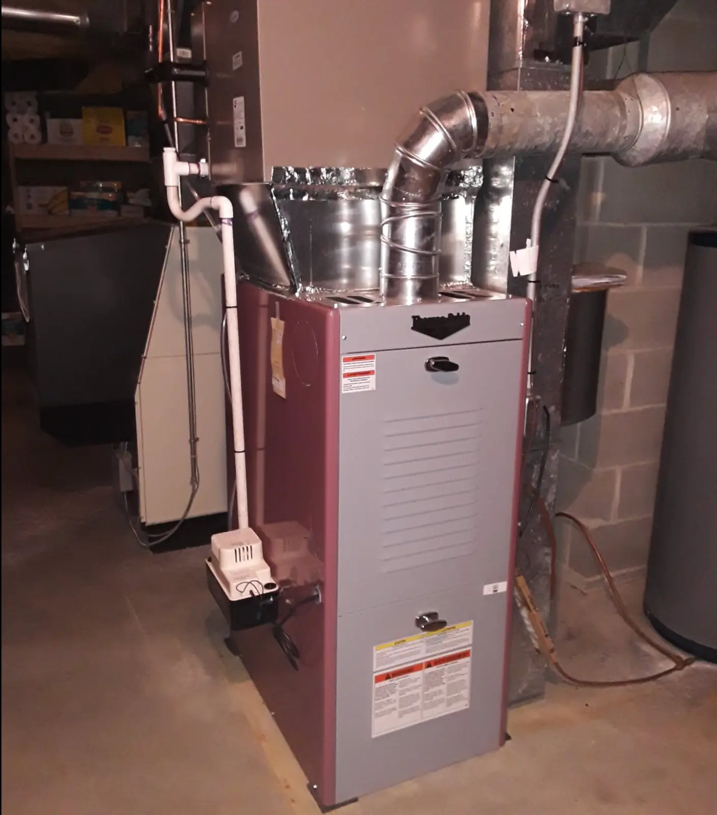 New furnace and sheet-metal ductwork installed in a utility space